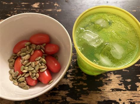 Cherry tomatoes and pumpkin seeds with a strawberry-flavored Bubly