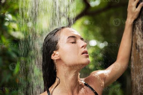 Beautiful woman taking outdoor shower in the tropical jungle 14396827