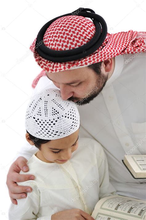 Middle eastern education, father kissing son while reading Koran ...