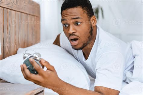Oversleeping. Overslept African American Man Looking In Shock At Broken