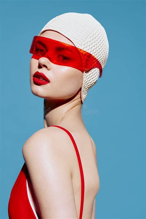 A Girl in a Swimming Cap Holds Her Hands on Her Waist and Poses Looking ...