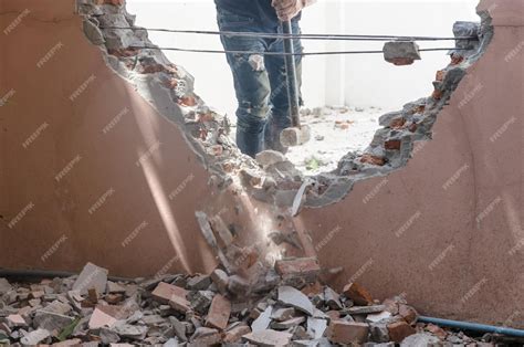 premium photo man  hammer smashed  walls   house