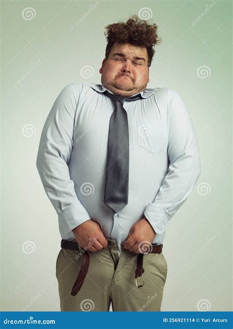 This is Going To Be a Tight Squeeze. an Overweight Man Sucking in His