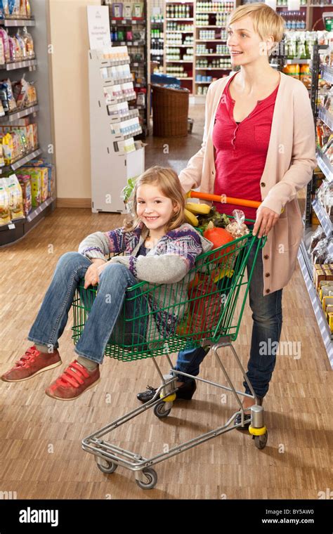 A mother and daughter shopping at the supermarket Stock Photo - Alamy