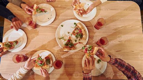 People eating pizza top view 16937098 Stock Photo at Vecteezy