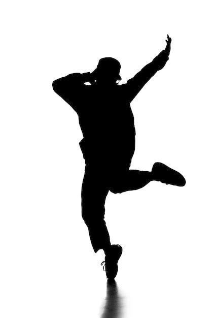 Premium Photo | Silhouette of hip hop dancer is showing some movements.