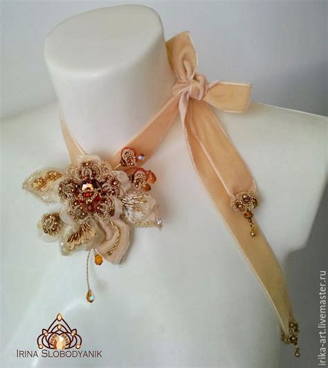 a white mannequin with an orange and gold flower on it