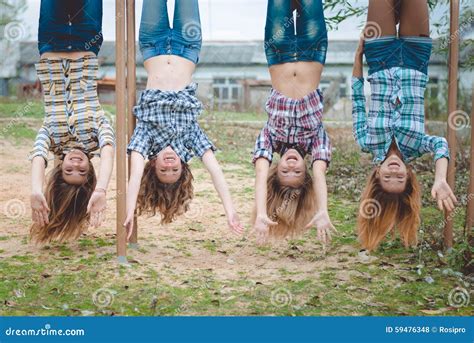 Four Young Funny Teenage Girls Hanging Upside Down Stock Photo - Image