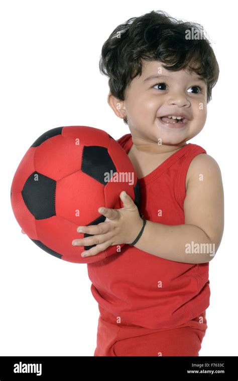 Baby boy holding ball Stock Photo - Alamy