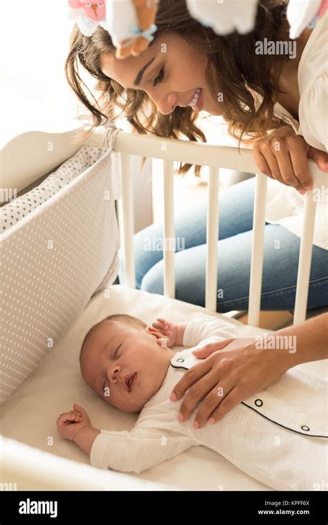 Mother putting baby to sleep at the crib Stock Photo - Alamy