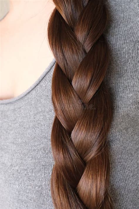 Young Woman, Brunette, Braids Her Long Beautiful Hair in Thick Braid ...