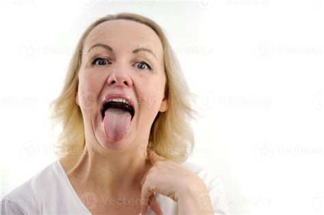 a woman shows her tongue healthy clean tongue Female tongue with a