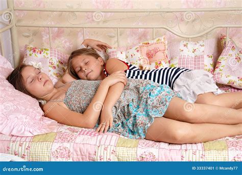 Two Little Girls Sleep in a Bed Stock Image - Image of expression