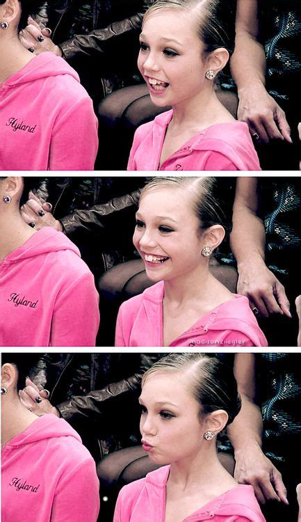 a woman in a pink dress is smiling