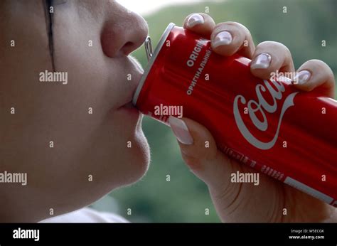 Coca cola woman drinking bottle hi-res stock photography and images - Alamy