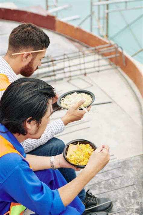 builder eating lunch construction site stock   royalty