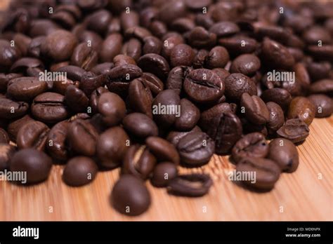 coffee beans fresh roasted close  macro  natural wood background