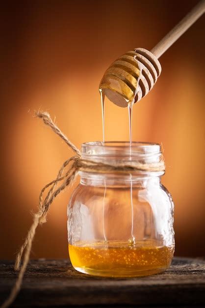 Free Photo | Honey jar with wooden spoon