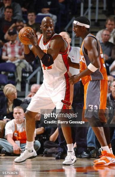 Kevin Willis of the Atlanta Hawks looks to play the ball against ...