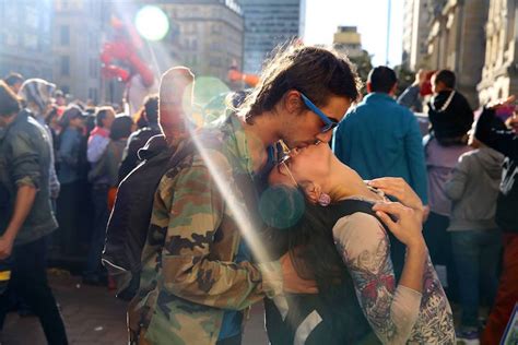 traveling photographer captures couples kissing  public   world