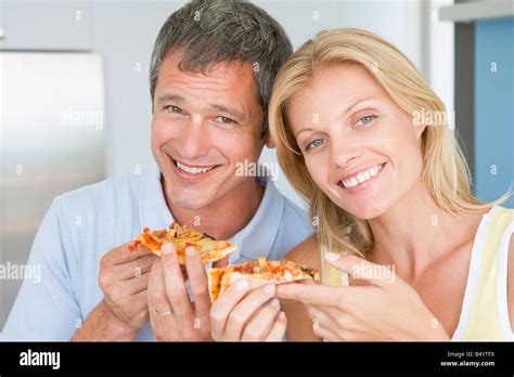 Husband And Wife Eating Pizza Stock Photo - Alamy