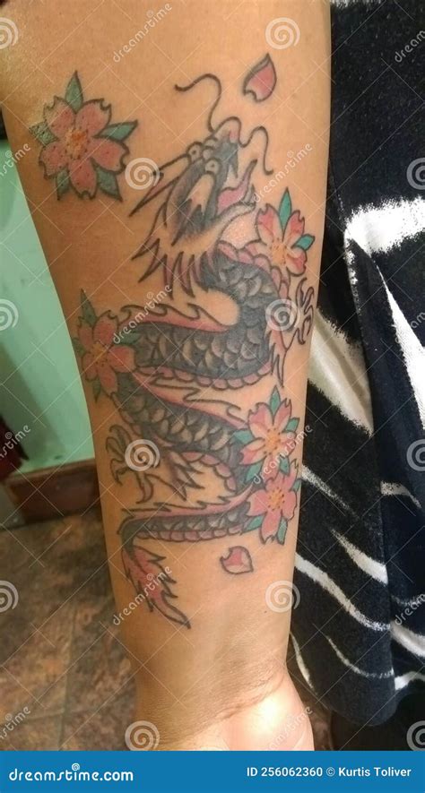 Tattoo on Woman of Colors Arm. Chinese Styled Dragon in Green, Red and ...
