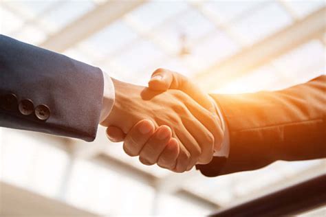 Download Businessmen Handshake With Sunset Light Picture | Wallpapers.com