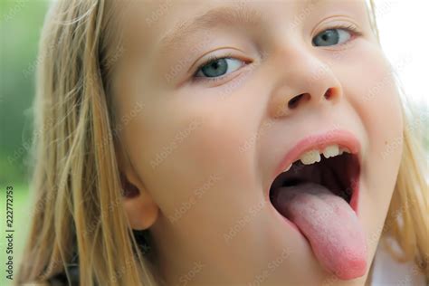 Small girl with put out tongue Stock Photo 