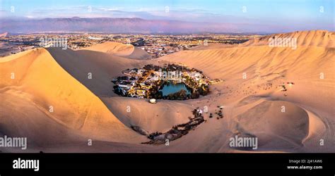 Aerial sunset view of the Huacachina Oasis in the Atacama desert of ...