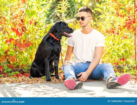 Guy with a Dog Walks in a Park in Autumn Stock Photo - Image of adult ...