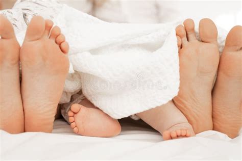 Barefoot Traditional Family, Woman, Man, Baby Foot on White Linen Bed, Blanket. Three Pairs of ...