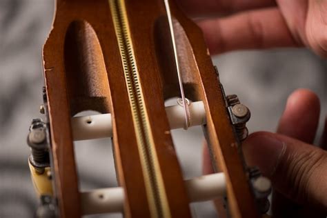 Premium Photo | Restring classical guitar