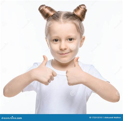 A Small Blonde Girl in a White T-shirt Shows a Like with Two Hands on a