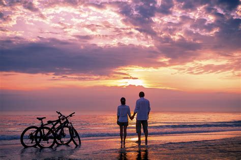 Thailand - Couple walking on the beach at sunset - EXO Travel Blog