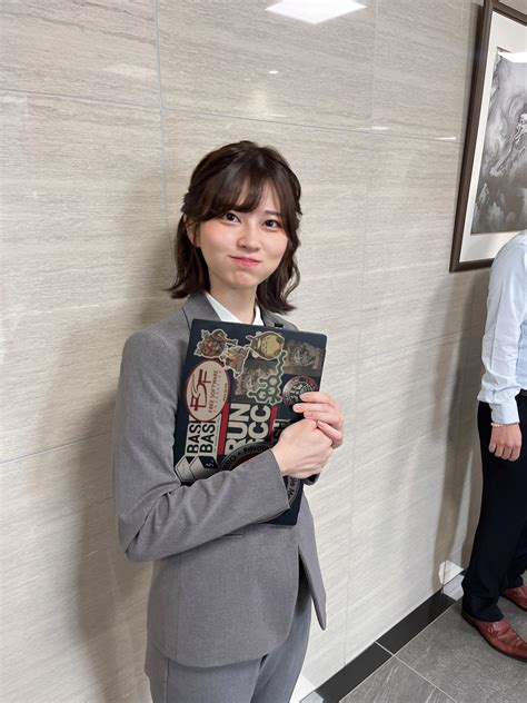 Saori Araki holding laptop adorned with stickers. | Know Your Meme