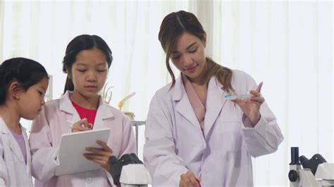 Asian schoolgirls are studying science and technology in a lab