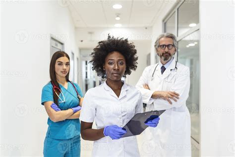 Closeup front view of group of mixed age doctors and nurses standing