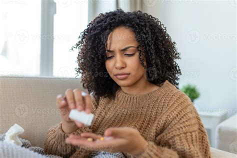 Millennial ill sick woman taking painkiller medicine to relieve
