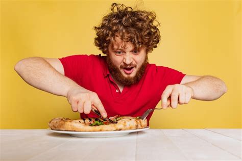Premium Photo | Young man getting ready to eat delicious Italian pizza ...