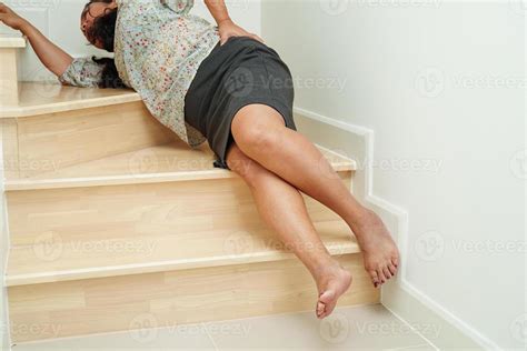Asian lady woman injuries from falling down on slippery surfaces stairs ...