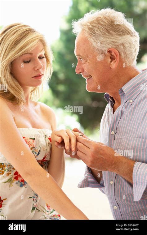 Senior man on knee giving hi-res stock photography and images - Alamy