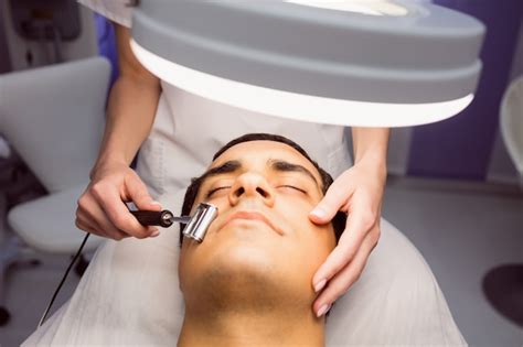 Free Photo | Dermatologist performing laser hair removal on patient