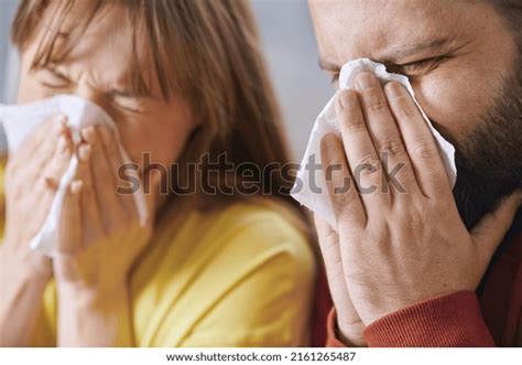 people blowing  noses sneezing stock photo