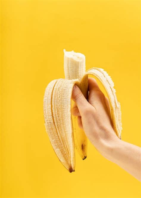 hand  holding  yellow banana stock photo image  peeled