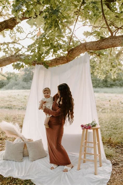 mommy   boho photoshoot white sheet outdoor grassy field brown