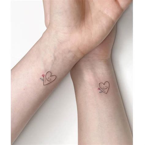 Matching smiley heart and flower tattoo for best