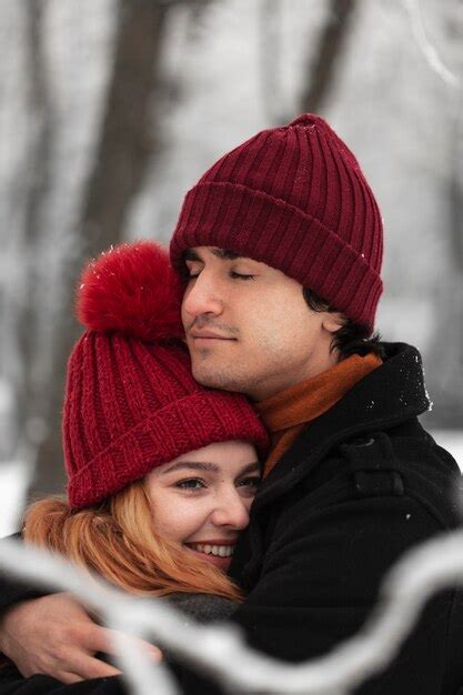 Free Photo | Snowy winter season with couple hugging