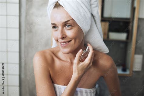 Woman Putting Perfume On Stock Photo | Adobe Stock