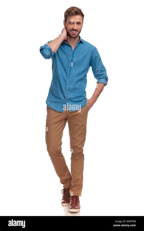 young casual man standing and posing on white background, with one hand ...