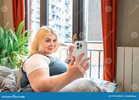 young beautiful smiling chubby  size woman making selfie  home